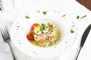 Russian Olivier salad with meat, quail eggs and cherry tomatoes