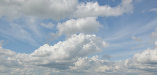 white clouds in the blue sky. fluffy clouds. background.