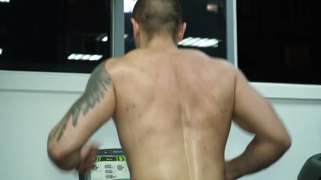The athlete runs along the treadmill in the gym