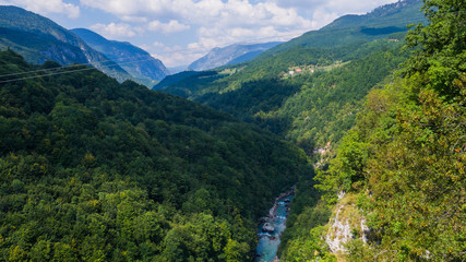 Fototapeta premium View on Tara river canyon in a cloudy day, mountains around, Montenegro, Dzurdzevica Bridge