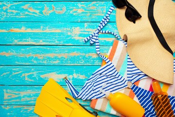Composition with swimsuit on color wooden background