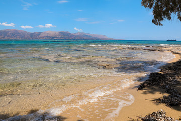 Sandy beach with aquamarine sea water in Elafonisos village island, Laconia, Peloponnese, Greece, June 2018.