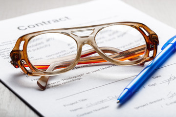 Close up shot of Eyeglasses  on contract document papers business concept