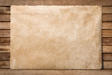 Old paper sheet at wooden background with clipping path