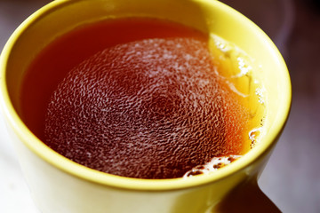 Top view of a hot cup on tea. Sunny morning on the balcony with a cup of tea.