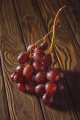 close-up shot of ripe red grapes on rustic wooden table