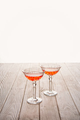 close-up shot of glasses of wine on wooden table on white