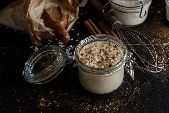 Glass jars with served rice and milk