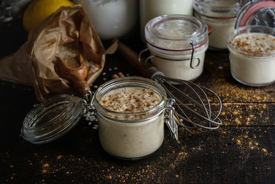 Glass jars with served rice and milk