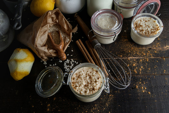 Glass jars with served rice and milk