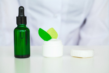 Organic Oil Souring. Woman Working at The Laboratory of Cosmetic Production.Private Small Cosmetic Products Factory. Young Technologist Making Face Care Creams. Private Cosmetic Products Factory