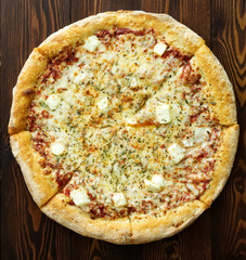 Four cheese pizza with Dor-blue, Parmesan, feta, oregano, mozzarella, tomato sauce, top view