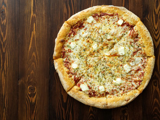 Four cheese pizza with Dor-blue, Parmesan, feta, oregano, mozzarella, tomato sauce, top view with copy space.