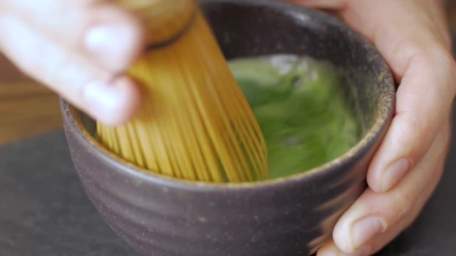 green matcha tea prepearing on stone black table