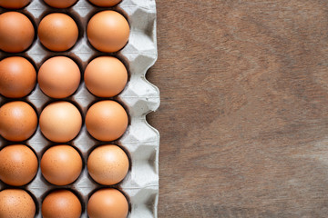 Fresh chicken eggs eggs in paper tray,egg carton on wooden background.