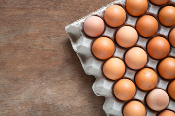Fresh chicken eggs eggs in paper tray,egg carton on wooden background.