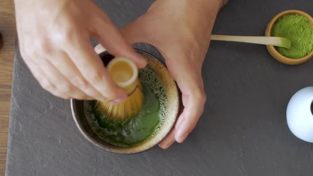 green matcha tea prepearing on stone black table