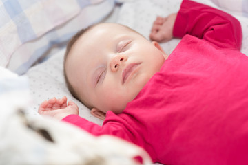 Portrait of baby sleeping in a crib