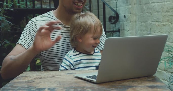 Father trying to work from home while looking after toddler