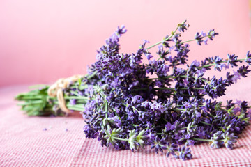 Violet lavender flowers arranged on bright purple background. Top view.