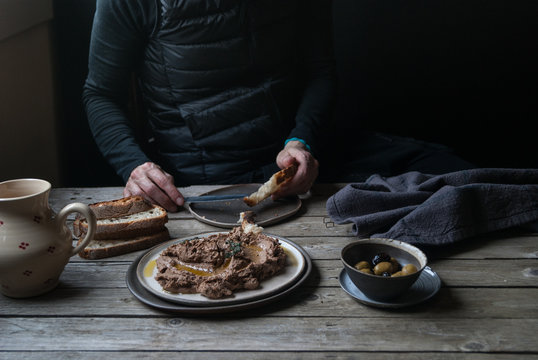 Man Spreading Lentil Pate On Bread