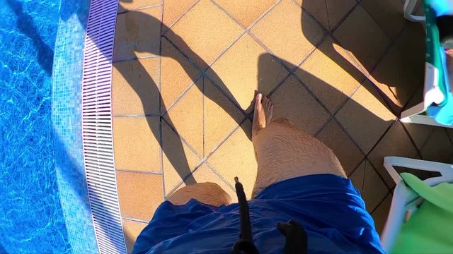 Professional video of man walking around the pool in slow motion 250fps
