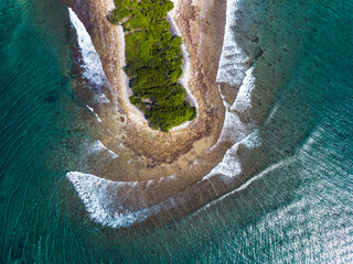 Aerial view of part of the island of Thanburudhoo with waves breaking over the reef, Maldives
