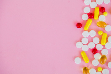 Medical Concept. Colored Pills And Capsule On Pink Background. Pharmacy Theme, Capsule Pills With Medicine Antibiotic in Packages