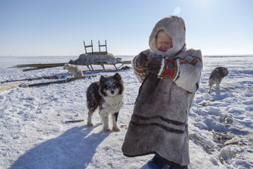 tundra, open area, the boy with a dog in cold winter weather, the boy  in national clothes,