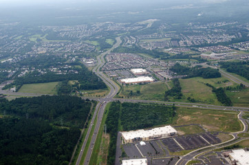 Aerial view of a town showing road fields homes