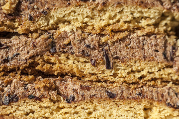 cake with walnuts, prunes and dried apricots on a dark wood background, selective focus