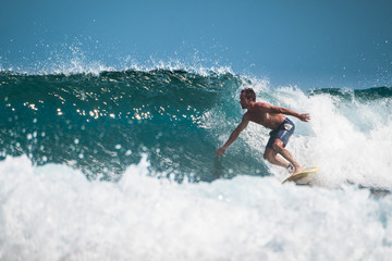 Amateur surfer rides the ocean wave