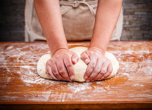 Female hands making dough