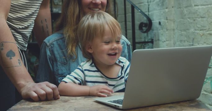 Young family in courtyard making video call