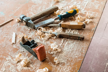 Old traditional carpentry tools with shavings. A hammer and a jointer plane