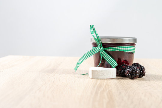 Decorated Glass Of Homemade Blackberry Jelly On A Wooden Table 