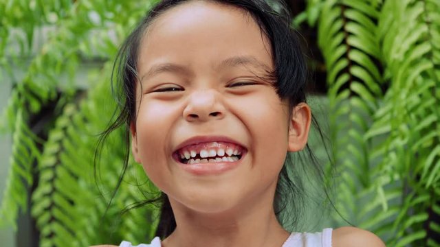Slow motion girl laughing hearing joke