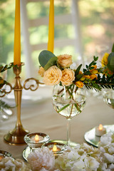 Yellow flowers details of the wedding table decorated with flowers. Floristic