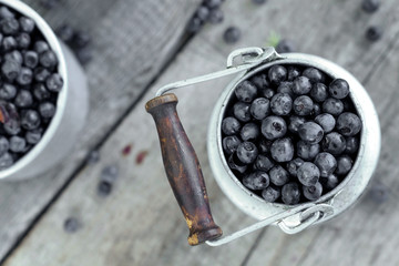 Fresh blueberry on old background in rustic style, selective focus, top view.