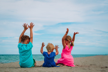happy kids-little boy and girls- have fun on beach