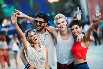 Group of friends having fun time at music festival