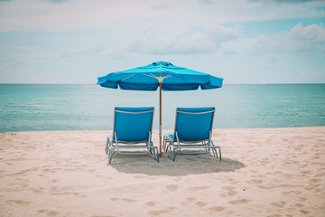 Two beach chairs on tropical vacation