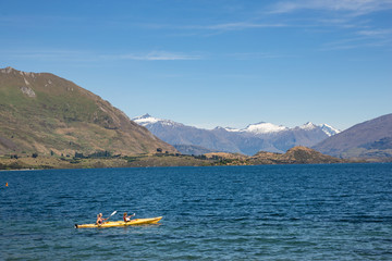 Two ladies kayaking on lake Wanaka, south island New Zealand