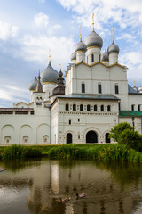 Fototapeta na wymiar Reflection of the Orthodox Cathedral of the Rostov Kremlin in the pond of the courtyard