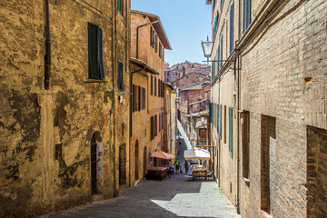 Fototapeta na wymiar Street in old mediaeval town in Tuscany, Siena