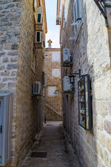 Narrow street of the old city. Ancient houses made of stone. Old Town of Budva. Montenegro