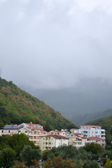 Becici, Montenegro, View of the city and mountains. Low white clouds over the city