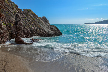 Beautiful sea view. The mountains descend into the sea. Blue sky with clouds and turquoise water. Adriatic Sea. Montenegro.