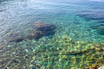 The sea view. Calm sea and large stones. Transparent water of the Adriatic Sea. Montenegro