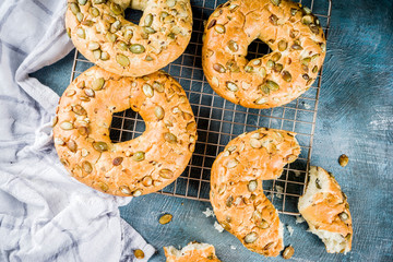 Healthy breakfast concept, home made cereal bagels with milk glass, on blue background copy space